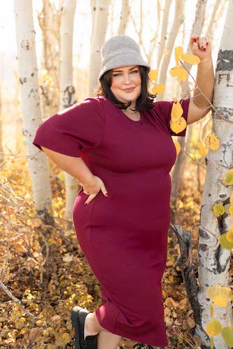 Woman wearing a maroon dress out in the woods