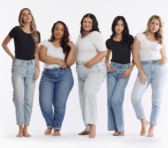 Group of women all wearing layering tees paired with jeans