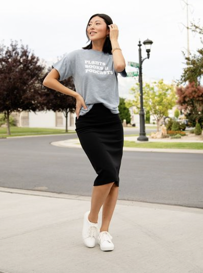 Woman outside wearing a knee-length skirt and short sleeve shirt