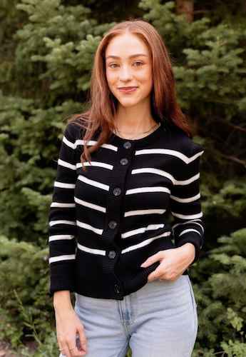 Woman wearing a buttoned up striped cardigan and jeans